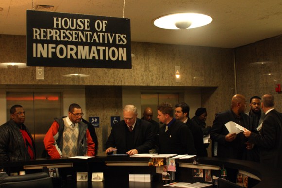 Rev. Bob Vanden Bosch (third from left) of Concerned Christian Ministries helps people locate their representatives' offices at the Stratton Building in downtown Springfield.