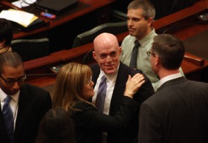The bill's sponsor, Rep. Greg Harris (D-Chicago), is congratulated after House members  voted 61-54 in favor of it, with two voting present.