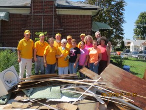 An Illinois Baptist Disaster Relief is cheered by a job well done in Warren, Michigan. Volunteers traveled north to assist with flood recovery in August and September.