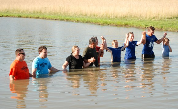 The Tennyson family was baptized in June by Pastors Bryan Henderson and Jacob Gray (left) of Ten Mile Baptist Church.