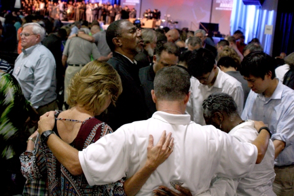 Prayer takes center stage (and all available floor space) as Marvin Parker, pastor of Broadview Missionary Baptist Church in Metro Chicago, and his wife, Inez, join with others in Columbus to pray for racial reconciliation.