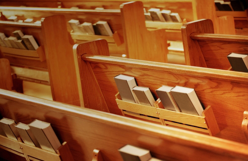 Church pews with hymnals
